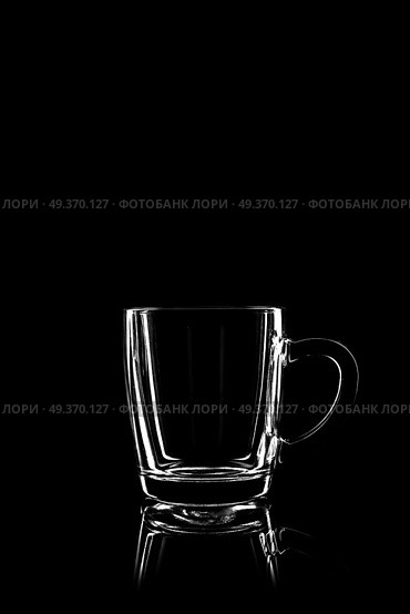 transparent glass for brandy or cognac on black background with reflection. Стоковое фото, агентство Ingram Publishing / Фотобанк Лори