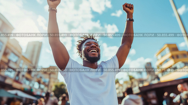 Triumphant Celebration: A Man's Joyful Success Moment in a Bustling Cityscape, Design for motivational poster or a victory announcement. Стоковое AI-изображение, AI-художник Данила Большаков / Фотобанк Лори