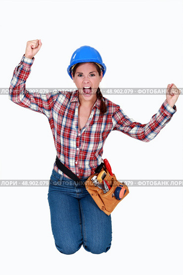 Triumphant female construction worker. Стоковое фото, агентство Ingram Publishing / Фотобанк Лори