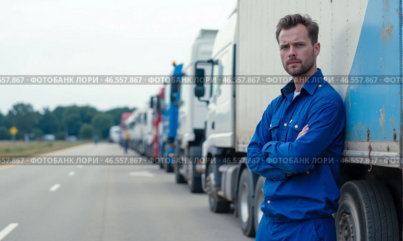 Truck driver standing confidently beside truck on highway with long line of parked trucks in background, wearing blue work uniform, looking serious, transportation industry, logistics, cargo delivery. Стоковое AI-изображение, AI-художник Павел Муравьев / Фотобанк Лори