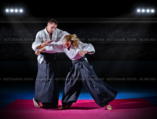 Two aikido fighters at sports hall. Стоковое фото, агентство Ingram Publishing / Фотобанк Лори