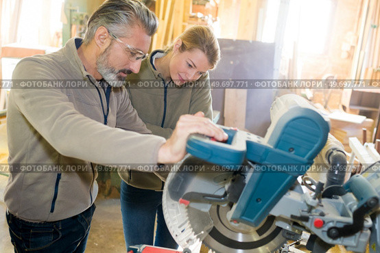 two carpenters using a circular saw. Стоковое фото, агентство Ingram Publishing / Фотобанк Лори