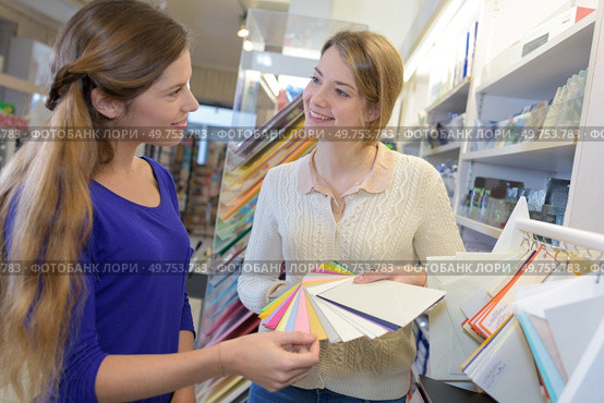 two female designers in office looking at different samples. Стоковое фото, агентство Ingram Publishing / Фотобанк Лори