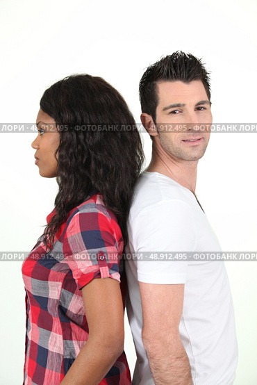 two people standing back to back. Стоковое фото, агентство Ingram Publishing / Фотобанк Лори