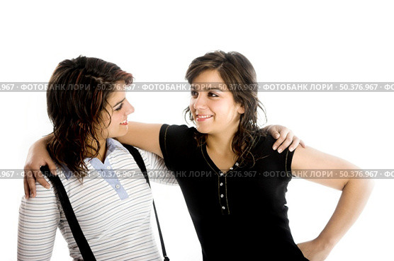 Two young beautiful sisters having fun isolated on white - This models are true twins. Стоковое фото, агентство Ingram Publishing / Фотобанк Лори