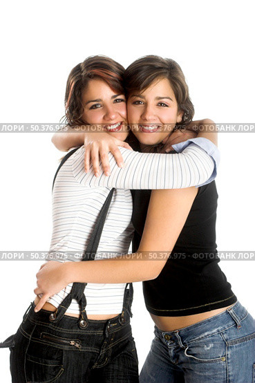 Two young beautiful sisters having fun isolated on white - This models are true twins. Стоковое фото, агентство Ingram Publishing / Фотобанк Лори
