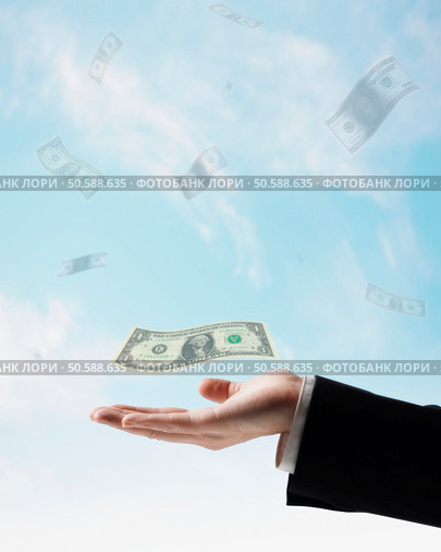 US Dollars floating in air above businessman’s hand. 24316768. Стоковое фото, агентство Ingram Publishing / Фотобанк Лори