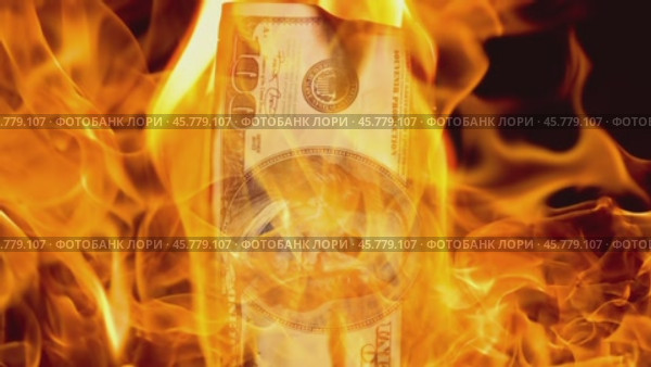 USA dollar bill money is burning in the fire, the concept of the economic crisis of inflation and currency devaluation. Стоковое видео, видеограф Андрей Армягов / Фотобанк Лори