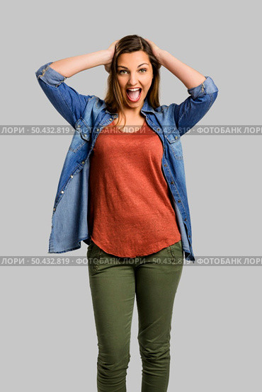 Very happy woman with hands on head and yelling really loud. Стоковое фото, агентство Ingram Publishing / Фотобанк Лори