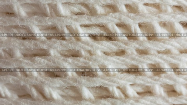 Video of a skein of natural cotton light yarn for hand knitting or crocheting. The texture of cotton threads wound into a ball. Textile background. Flat lay, macro, top view, close-up. Стоковое видео, видеограф Виктория Катьянова / Фотобанк Лори