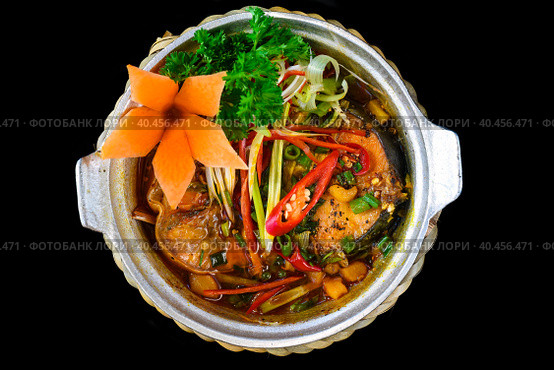 Vietnamese fried Mackerel fish with sauce on black background. Стоковое фото, фотограф Татьяна Терехина / Фотобанк Лори