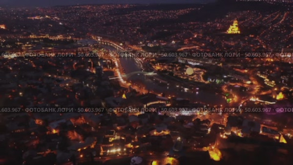 View from copter of illuminated center of Tbilisi city in the evening, Georgia. Стоковое видео, видеограф Яков Филимонов / Фотобанк Лори