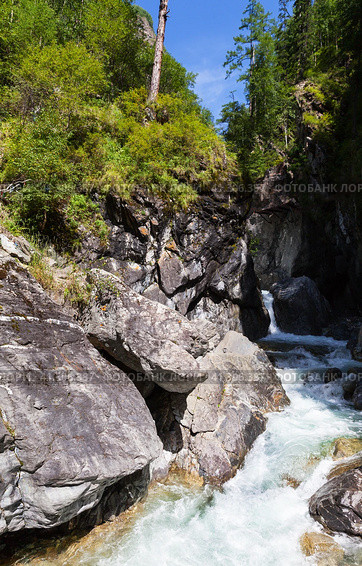 View of waterfall on mountain river Kyngarga at village Arshan in Tunka valley. Many tourists climb mountains to admire beautiful cascade of waterfalls. Summer activity outdoorsl. Siberia. Buryatia. Arshan resort. Стоковое фото, фотограф Виктория Катьянова / Фотобанк Лори