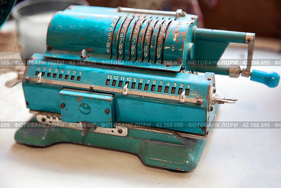 Vintage adding machine on white surface. Стоковое фото, фотограф Евгений Ткачёв / Фотобанк Лори