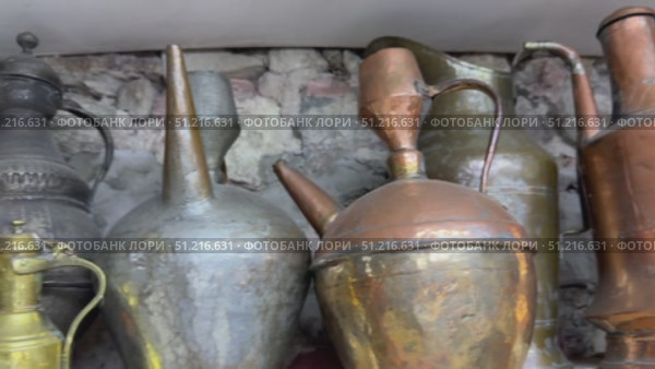 Vintage metal pitchers, pots, and jugs on wooden shelves Antique copper kitchenware at a traditional market Antique copper jug ​​on white background a group of five copper glazed jugs Cutout and isolated and transparent background image Elegant antique jugs and vases a collection of exquisite pottery Antique copper jug placed on an old wooden shelf, surrounded by vintage decor in a cozy living room. Стоковое видео, видеограф Zita Khasanova / Фотобанк Лори