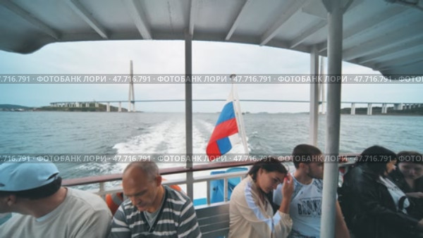 Vladivostok, Russia - August 9, 2021: Tourists ride the ferry on the bay. Редакционное видео, видеограф Mikhail Davidovich / Фотобанк Лори
