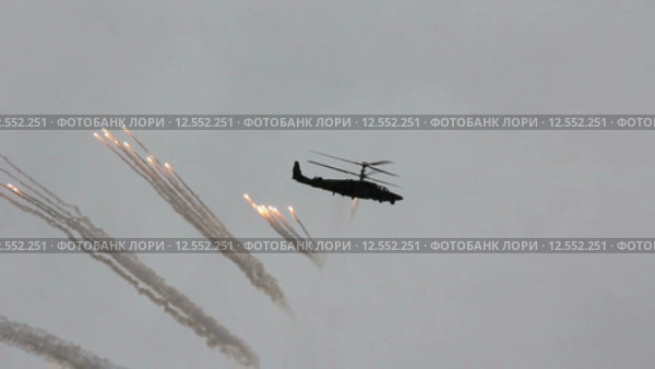 Военный вертолет Ка-52 выполняет показательную стрельбу в небе (2015 год). Редакционное видео, видеограф Фотограф / Фотобанк Лори