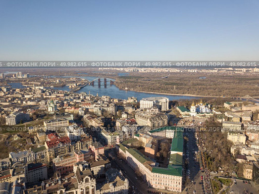 Vozdvizhenka District, the Museum of the History of Kiev, the Alexander Church and in the distance Obolon District with the Dnieper River and a bridge that connects the two banks of the city of Kiev, Ukraine. Photo from the drone. view landscape in Kiev with Vozdvizhenka District, the Museum of the History of Kiev, the Alexander Church and in the distance Obolon District. Стоковое фото, агентство Ingram Publishing / Фотобанк Лори