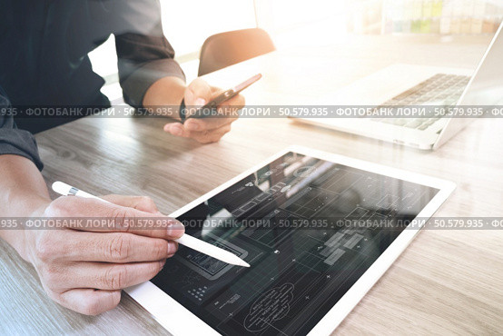 Website designer working digital tablet and computer laptop and digital design diagram on wooden desk as concept. Стоковое фото, агентство Ingram Publishing / Фотобанк Лори
