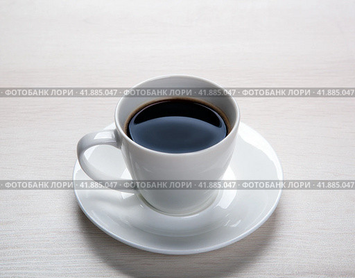 White cup with black coffee and saucer on the table. Стоковое фото, фотограф Александр Калугин / Фотобанк Лори