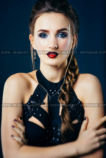 white girl modell on a dark background in a dress made of cut stripes of black fabric. Стоковое фото, агентство Ingram Publishing / Фотобанк Лори