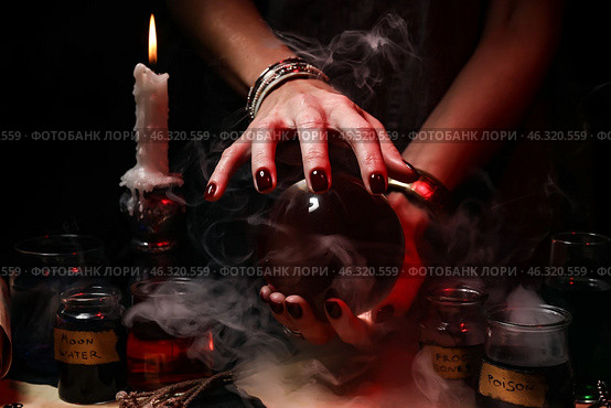 Witch with crystal ball on dark background. Стоковое фото, фотограф Pixel_shot / Фотобанк Лори