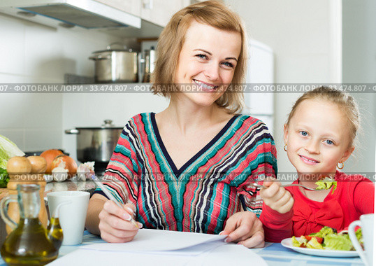 woman and her daughter working with papers from home. Стоковое фото, фотограф Яков Филимонов / Фотобанк Лори