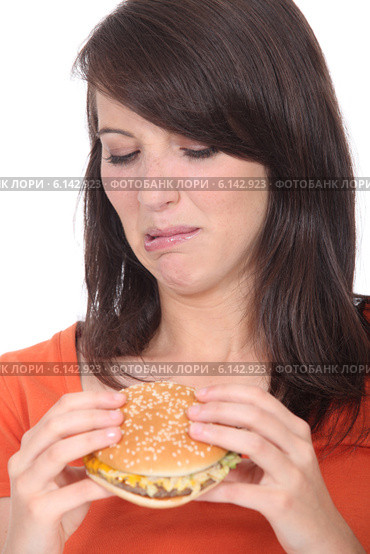 Woman eating a hamburger. Стоковое фото, фотограф Phovoir Images / Фотобанк Лори