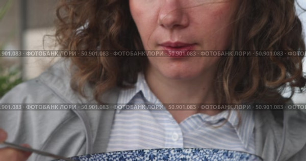 Woman eating noodles from a blue and white bowl. Стоковое видео, видеограф Ekaterina Demidova / Фотобанк Лори