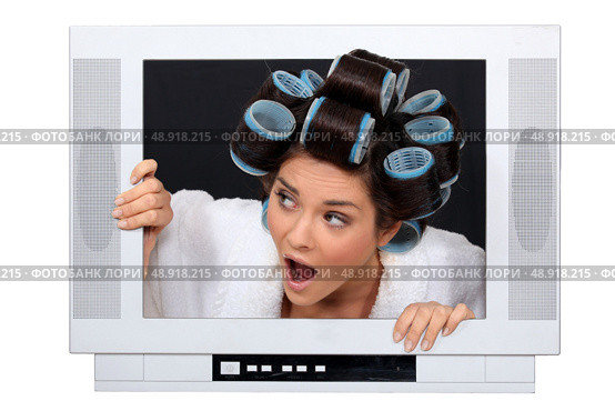 Woman escaping from television set. Стоковое фото, агентство Ingram Publishing / Фотобанк Лори