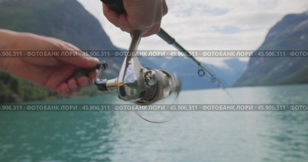 Woman fishing on Fishing rod spinning in Norway. Стоковое видео, видеограф Андрей Армягов / Фотобанк Лори