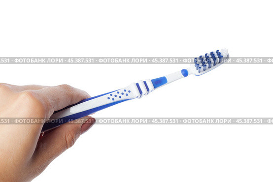 Woman hand holding a toothbrush isolated on white. Стоковое фото, фотограф Сергей Толмачёв / Фотобанк Лори