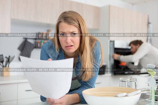woman looking at letter with an expression of dismay. Стоковое фото, агентство Ingram Publishing / Фотобанк Лори