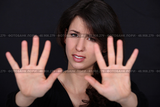woman making a stop sign gesture with her hands. Стоковое фото, агентство Ingram Publishing / Фотобанк Лори