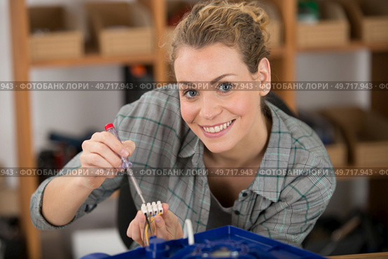 woman wiring up an electrical appliance. Стоковое фото, агентство Ingram Publishing / Фотобанк Лори