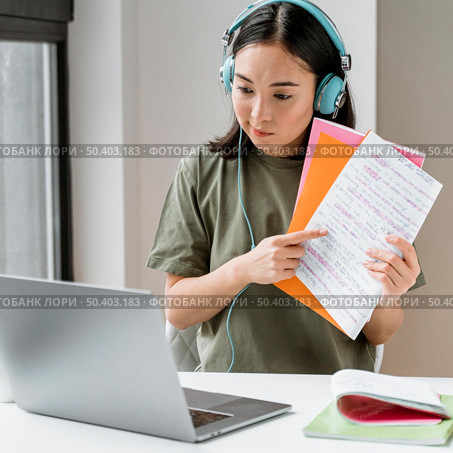 woman with headphones having video call laptop 2. Стоковое фото, агентство Ingram Publishing / Фотобанк Лори
