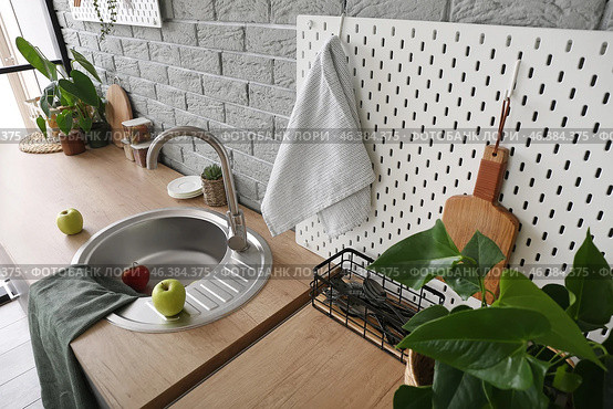 Wooden counter and pegboard with kitchen utensils near grey brick wall. Стоковое фото, фотограф Pixel_shot / Фотобанк Лори