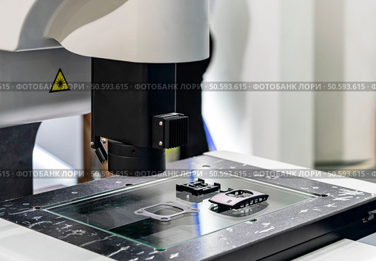 workpiece during inspection dimension shape appearance etc. by high technology precision video measuring machine with visual camera for quality control of manufacturing process. Стоковое фото, агентство Ingram Publishing / Фотобанк Лори