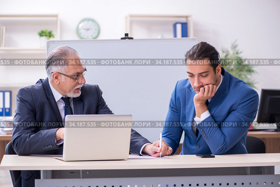 Yound and old employees in business presentation concept. Стоковое фото, фотограф Elnur / Фотобанк Лори