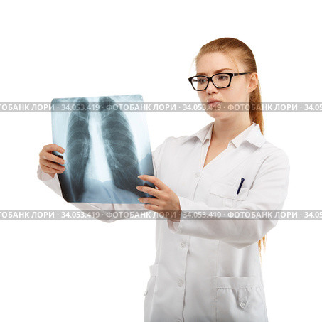 Young beautiful woman doctor inspects an X-ray of the chest and spine. Стоковое фото, фотограф Nataliia Zhekova / Фотобанк Лори