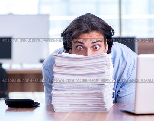 Young employee unhappy with excessive work. Стоковое фото, фотограф Elnur / Фотобанк Лори