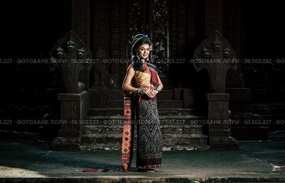 Young female Actress wearing beautiful ancient costumes, in ancient monuments, dramatic style. Perform on legend love popular story, Thai Isan folktale called "Phadaeng and Nang-ai" in acient site. Стоковое фото, агентство Ingram Publishing / Фотобанк Лори