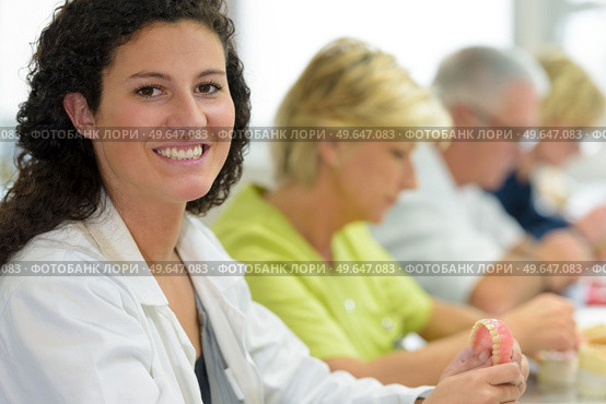 young female dental technician posing and smiling. Стоковое фото, агентство Ingram Publishing / Фотобанк Лори