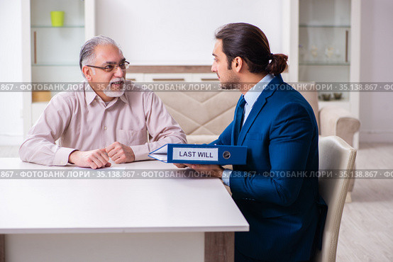 Young male lawyer visiting old man in testament concept. Стоковое фото, фотограф Elnur / Фотобанк Лори