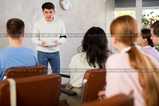 Young man teacher conducting lesson with group of students. Стоковое фото, фотограф Яков Филимонов / Фотобанк Лори