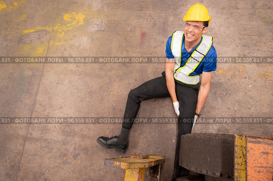 Young man working in a steel industry factory. He was critically hurt when a forklift ran over his leg and had to be transported to the hospital. Стоковое фото, агентство Ingram Publishing / Фотобанк Лори