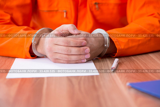 Young man writing letter in provisional detention. Стоковое фото, фотограф Elnur / Фотобанк Лори