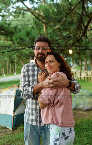 Young married couple feel happy and smile, standing in the forest in the evening. Стоковое фото, фотограф Татьяна Терехина / Фотобанк Лори
