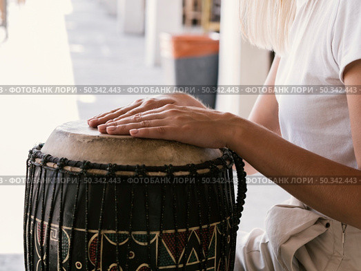 young person playing latin percussion instrument. Стоковое фото, агентство Ingram Publishing / Фотобанк Лори