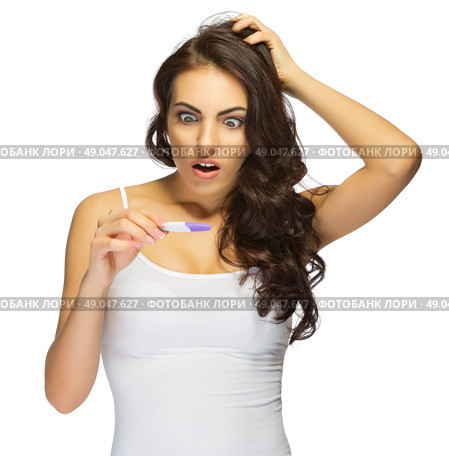 Young surprised girl with pregnancy test isolated. Стоковое фото, агентство Ingram Publishing / Фотобанк Лори